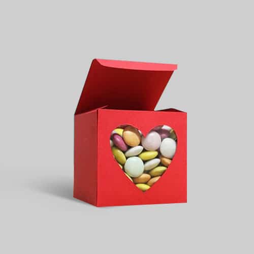 Red custom candy box with heart-shaped window displaying colorful chocolates.