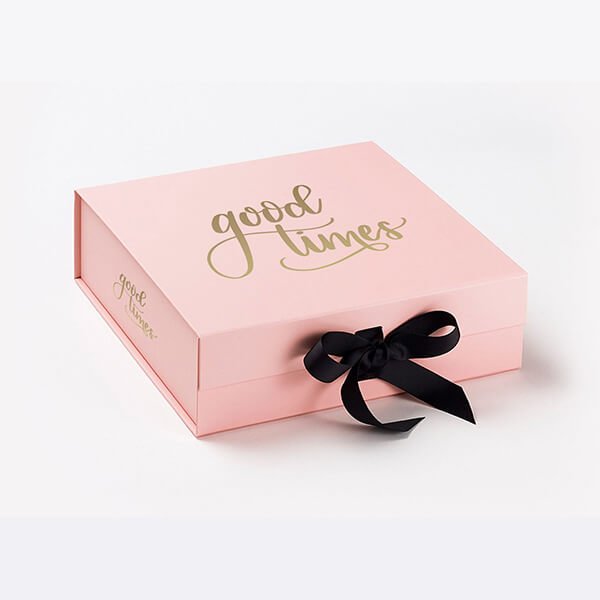 Luxury pink gift box with 'Good Times' gold lettering and a black ribbon bow